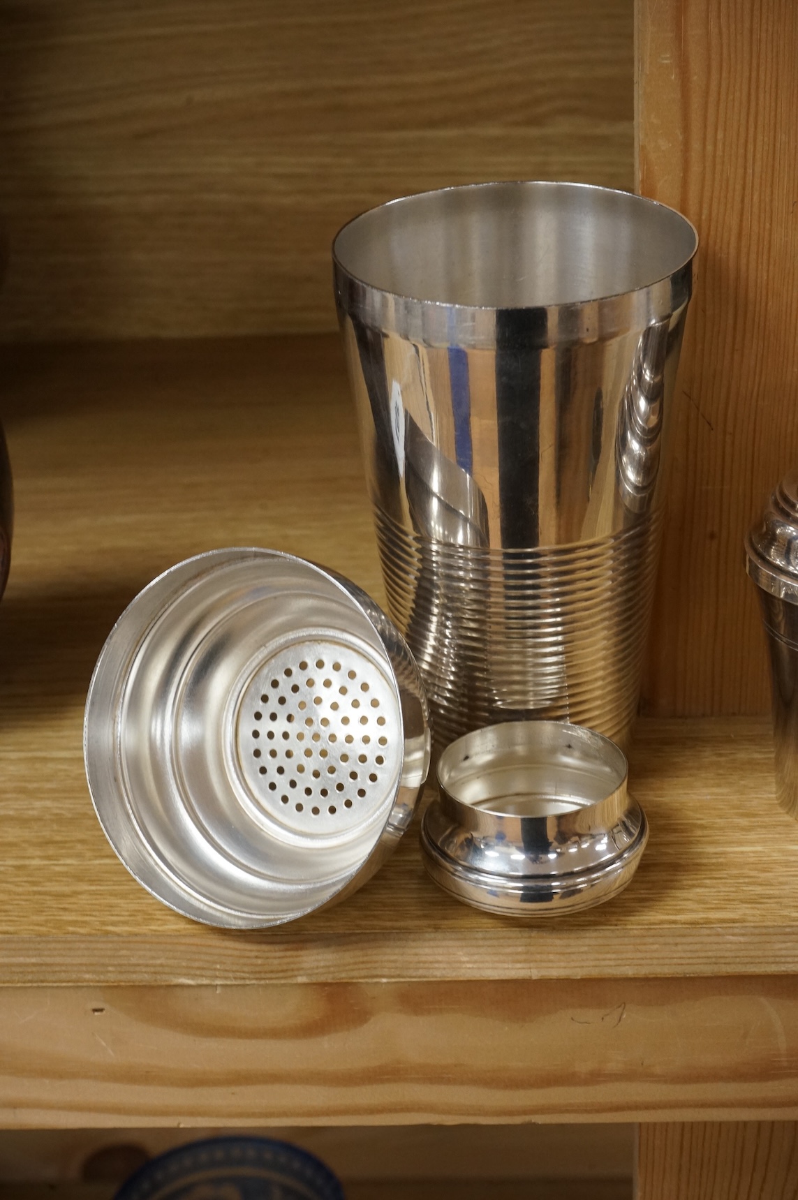 A small cocktail individual shaker and another larger example, 21cm high